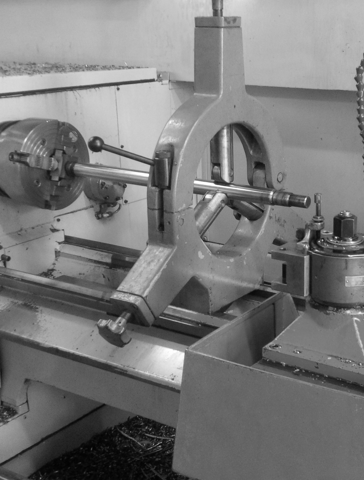 Lathe turning hydraulic cylinder rod with steady rest.